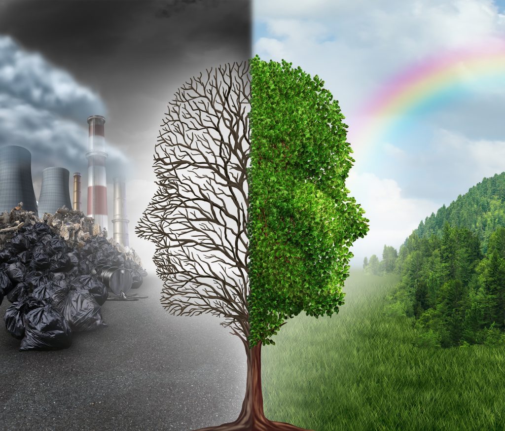 Environment change and global warming environmental concept as a scene cut in two with one half showing a dead tree shaped as a human head with pollution and the opposite with healthy green clean air and plants.