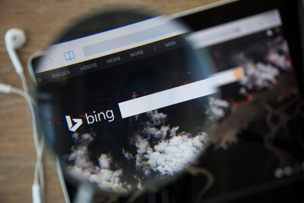 CHIANGMAI, THAILAND - February 26, 2015: Photo of Bing homepage on a ipad monitor screen through a magnifying glass.