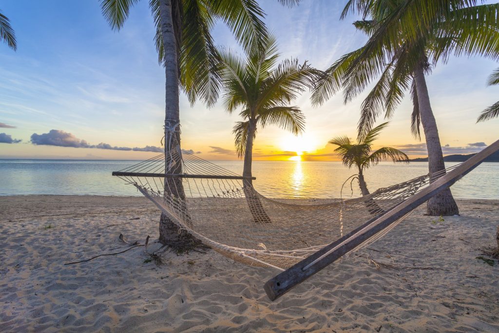 19254502 - tropical paradise beach at sunset with hammock