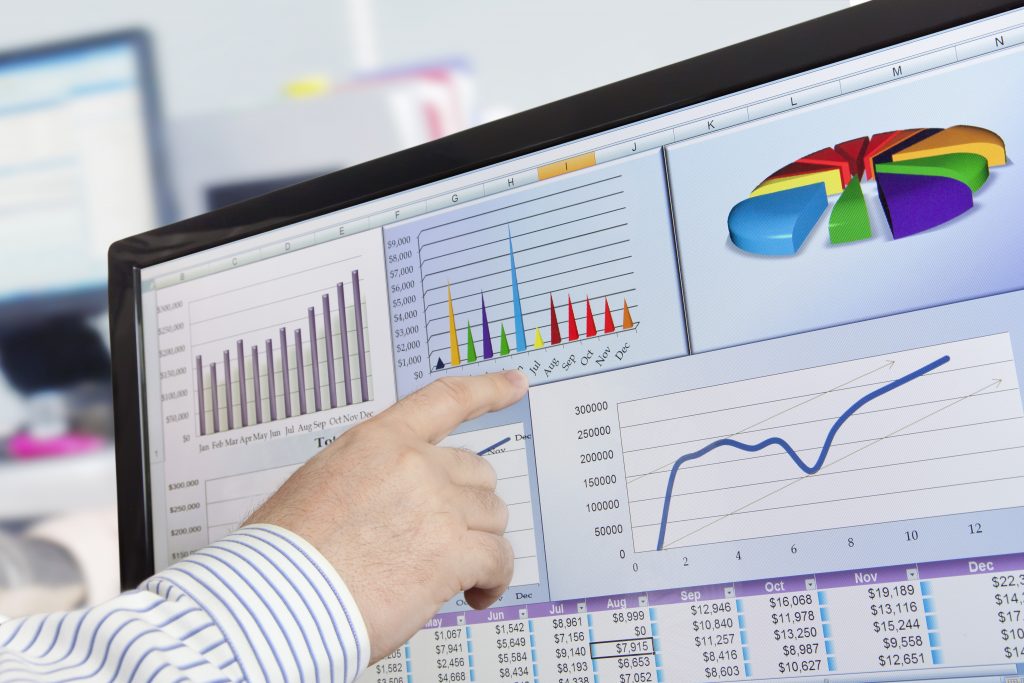 12866604 - man analyzing financial data and charts on computer screen