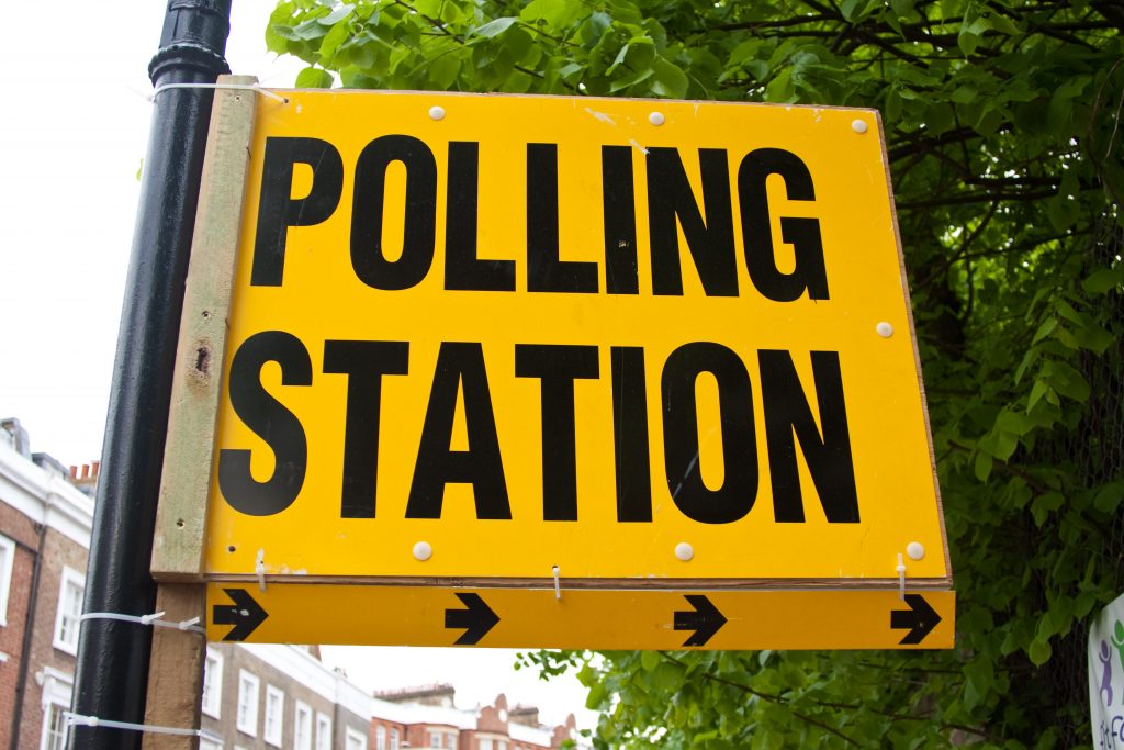 A yellow and black polling station sign, UK