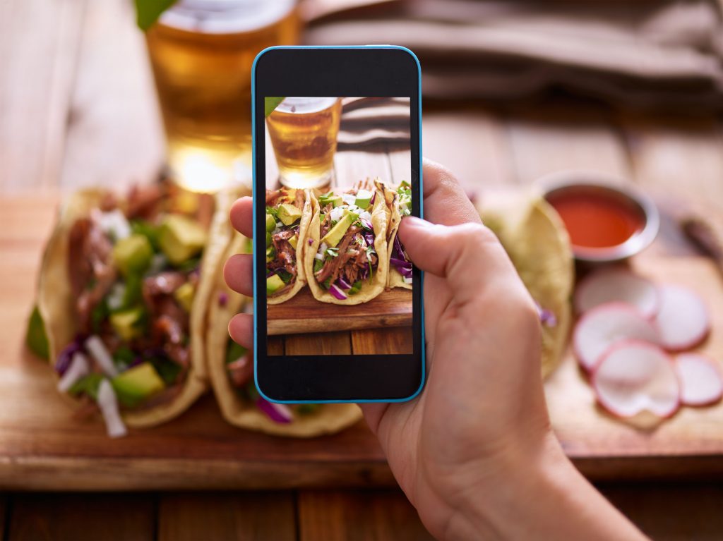 59835679 - taking photo of street tacos with smartphone