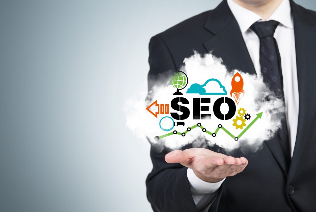 A manager is holding a cloud with the SEO cloud. seo 
search engine optimization optimisation   organic search results 