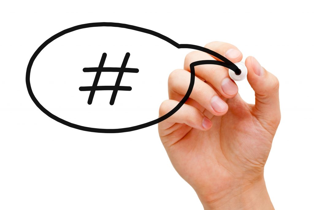 25262654 - hand sketching hashtag speech bubble concept with black marker on transparent wipe board.