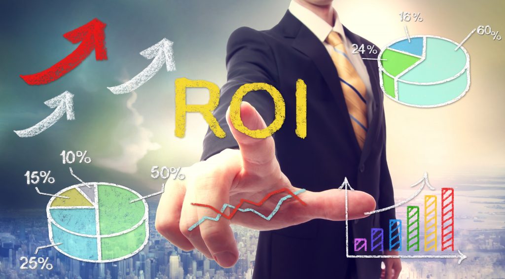 Businessman touching ROI (return on investment) over skyline background