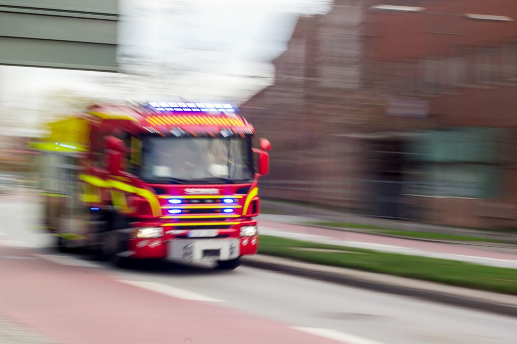 33435538 - malmo, sweden - october 26: very fast driving red scania fire truck in malmo, sweden on october 26, 2014.
