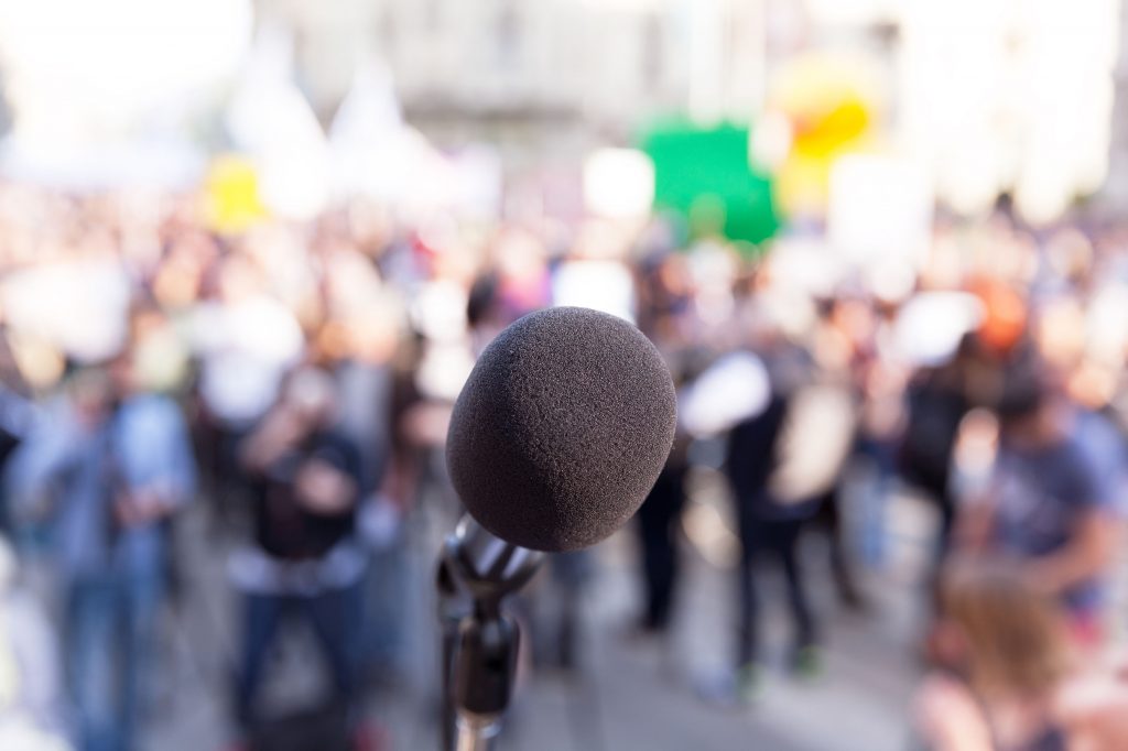 77295318 - protest. public demonstration. microphone.