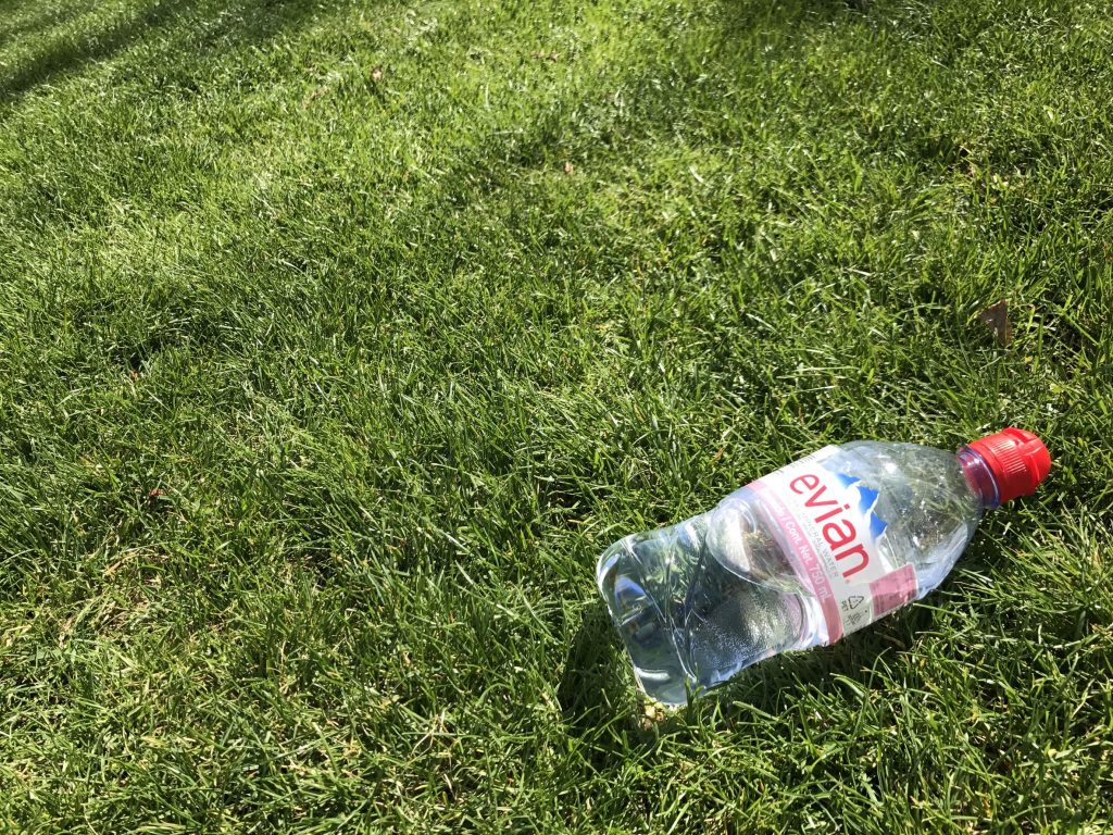76378755 - iasi, romania - april 10, 2017: bottle of evian water on the green grass