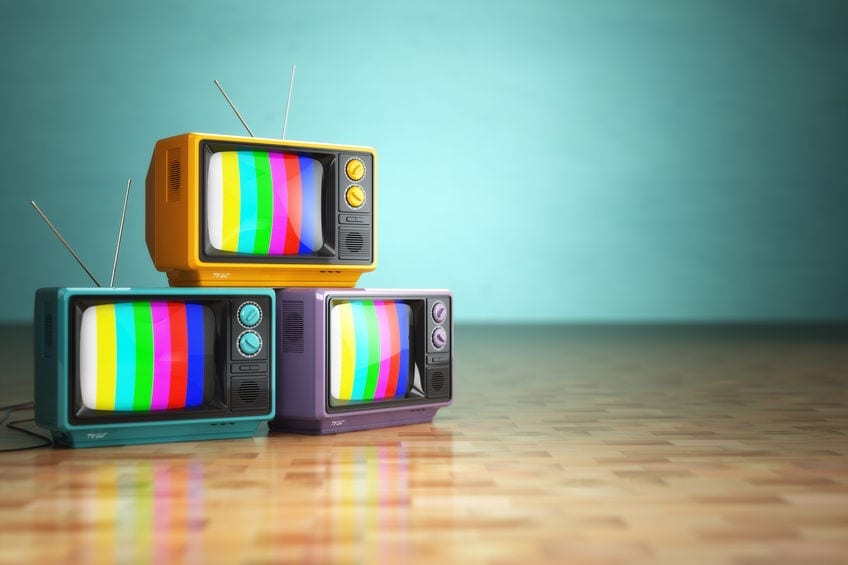 38068661 - vintage television concept. stack of retro tv set on green background. 3d